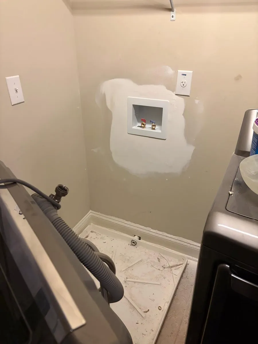 New recessed washing machine outlet box with hot and cold shutoff valves installed in a laundry room wall